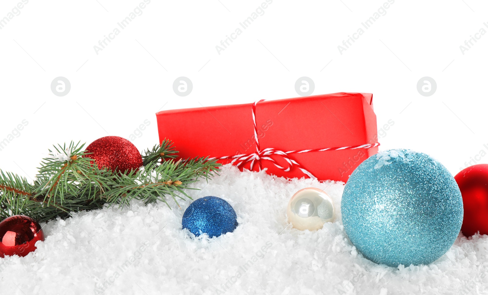 Photo of Christmas decoration with gift box on snow against white background