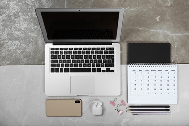 Photo of Flat lay composition with laptop on marble table. Designer workplace