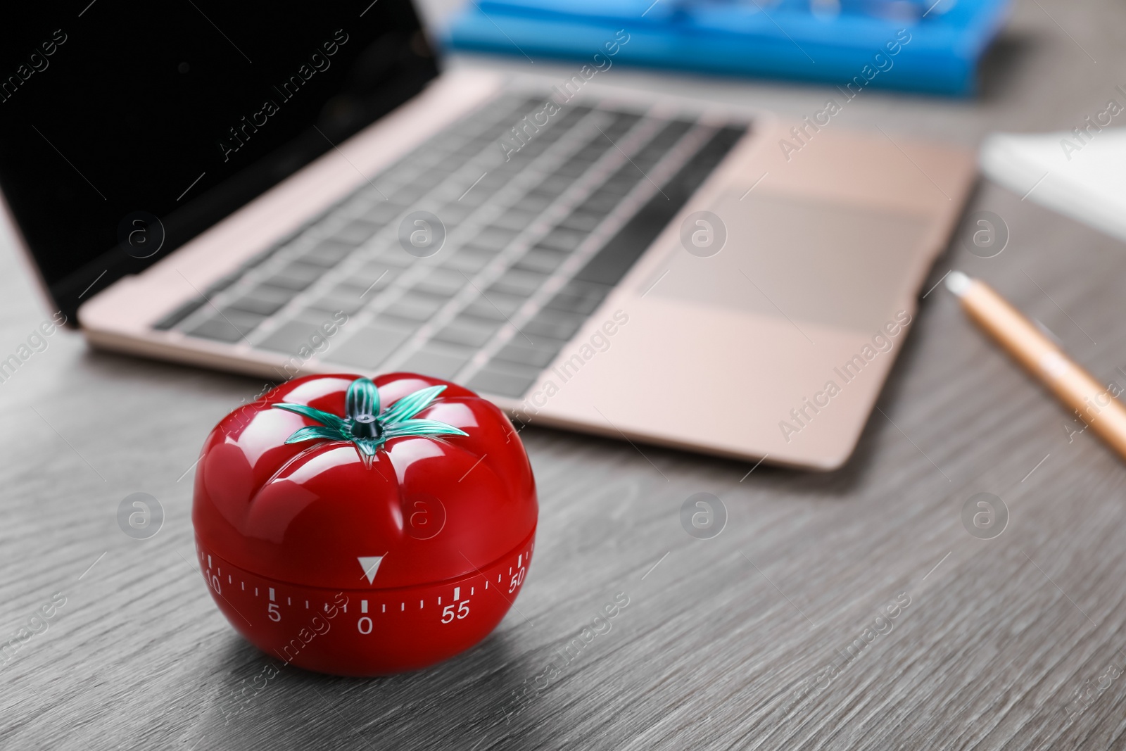 Photo of Kitchen timer in shape of tomato and laptop on wooden table, space for text