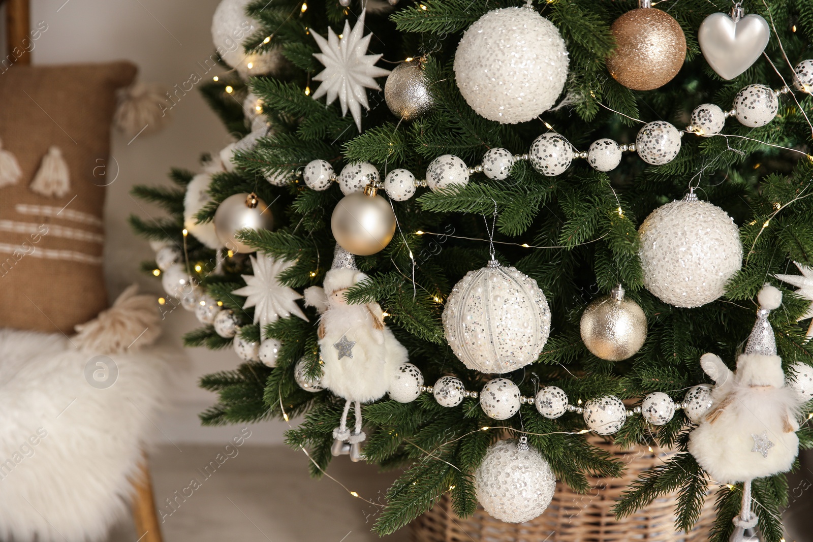 Photo of Beautiful decorated Christmas tree with baubles and garland indoors, closeup