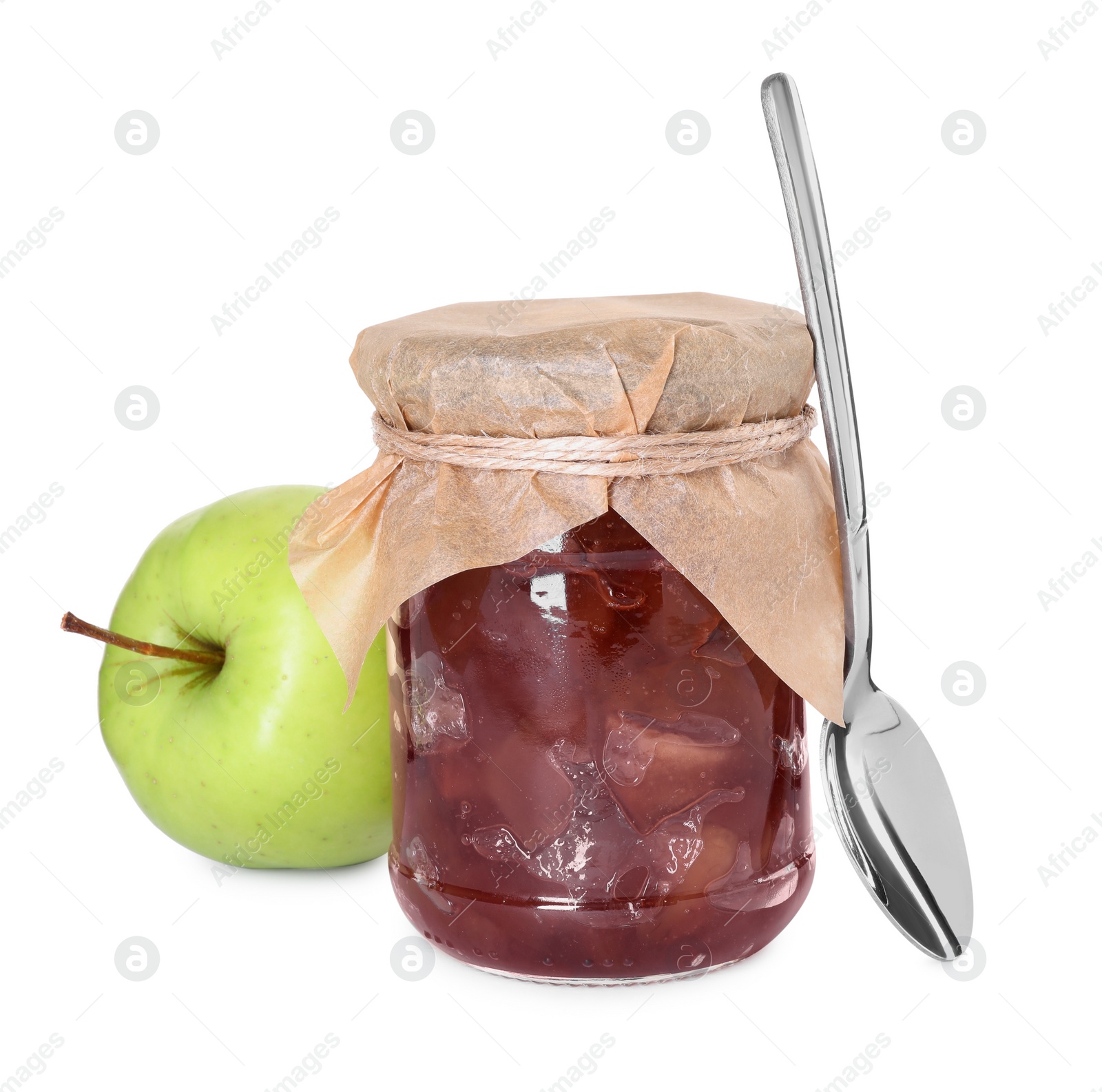 Photo of Glass jar of delicious apple jam, fresh fruit and spoon isolated on white