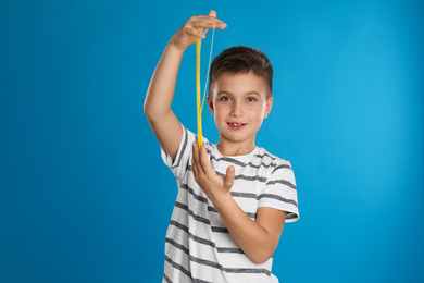 Photo of Little boy with slime on blue background