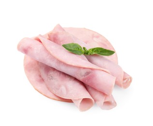 Rolled slices of tasty ham and basil isolated on white