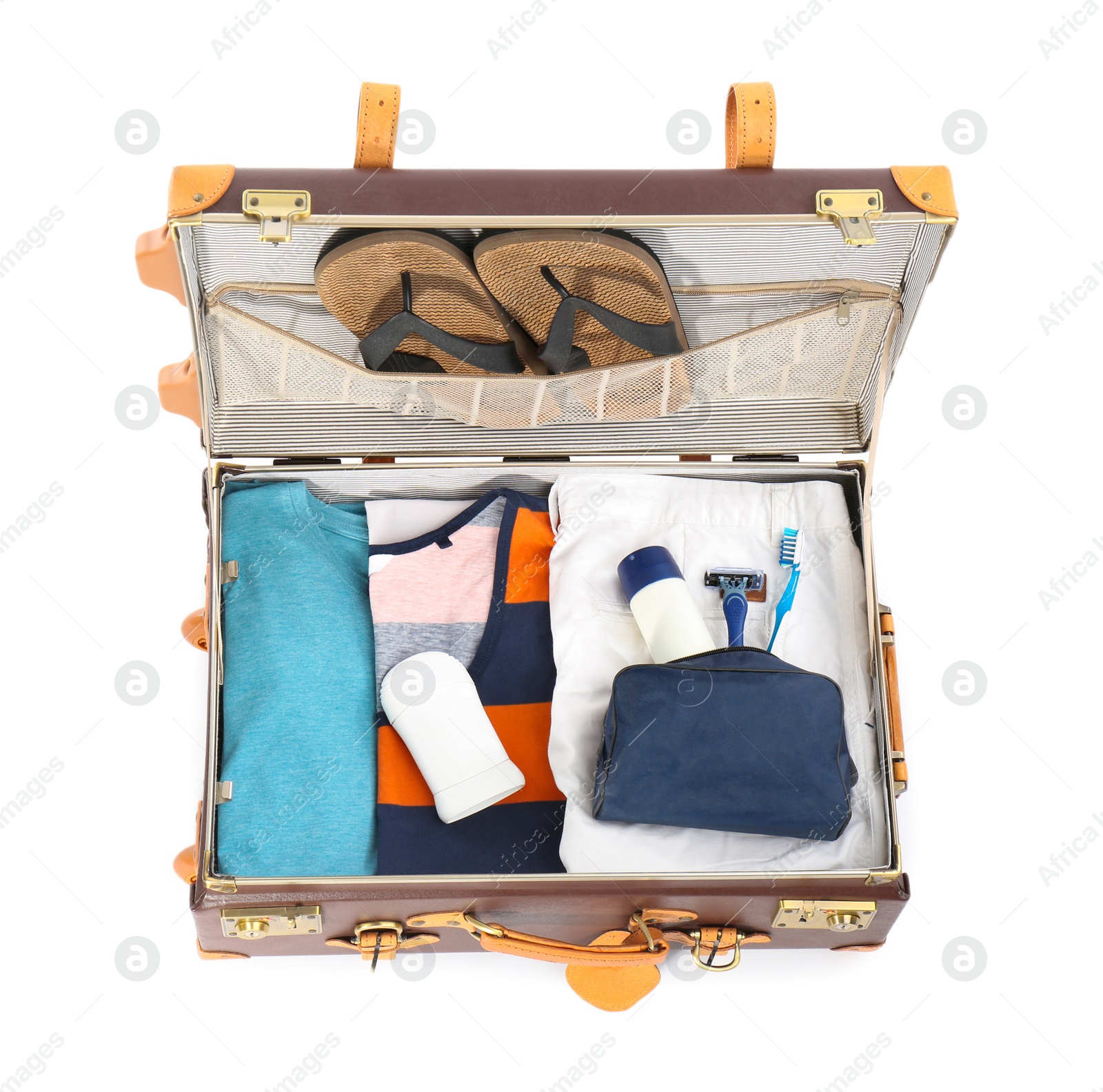 Photo of Packed suitcase with deodorants and clothes on white background