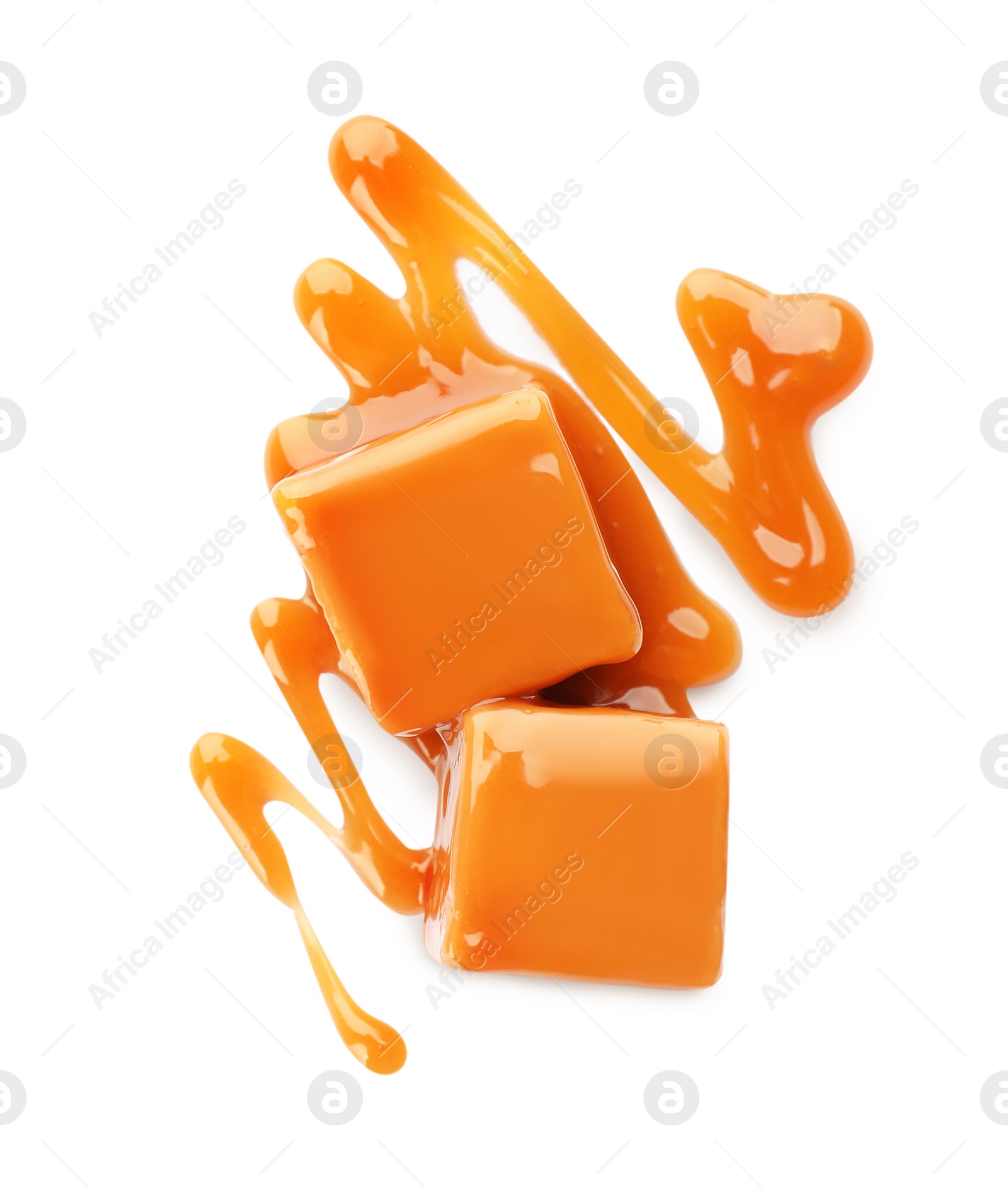 Photo of Sweet caramel candies with topping isolated on white, top view