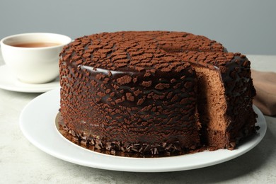 Photo of Delicious chocolate truffle cake on grey table