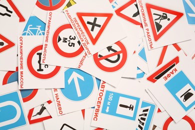 Many different road signs as background, top view. Driving school