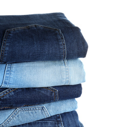 Stack of different jeans isolated on white