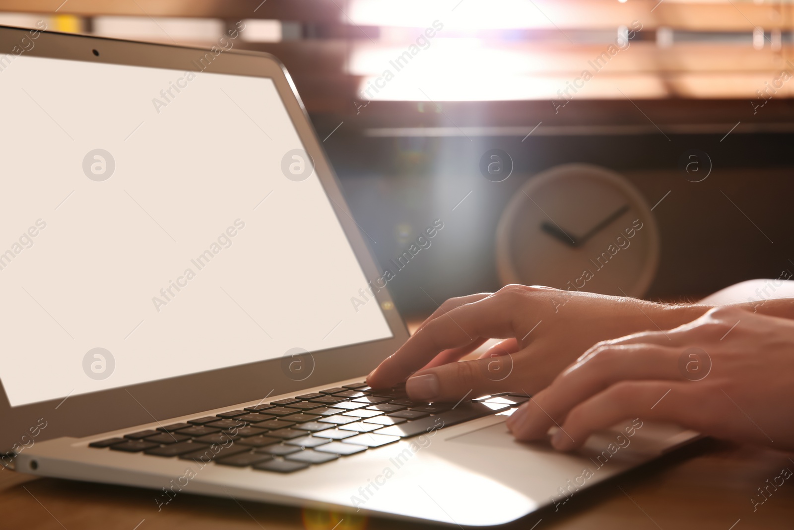 Photo of Woman using modern laptop at table indoors, closeup