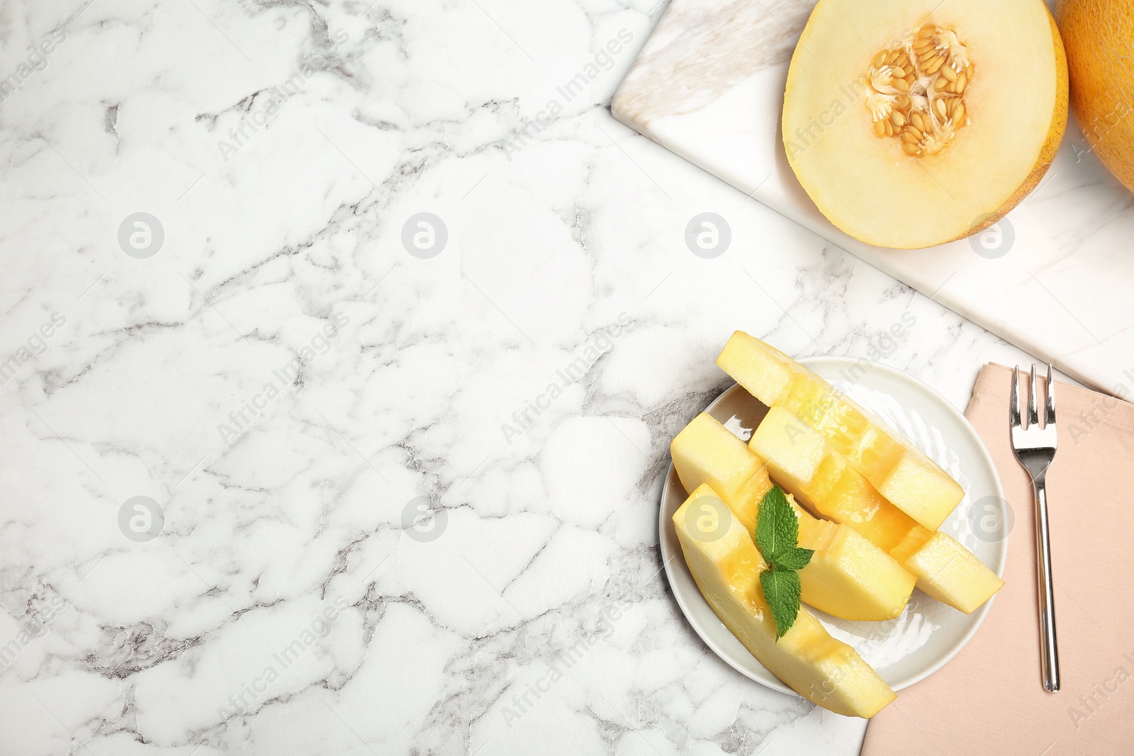 Photo of Flat lay composition with cut tasty melon on table. Space for text