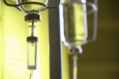 Photo of IV drip against blurred yellow background, space for text