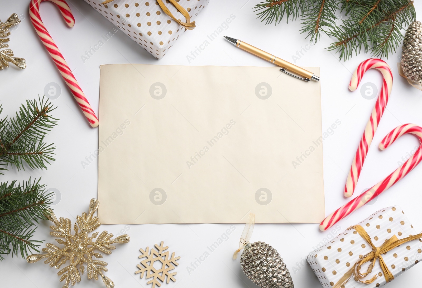 Photo of Flat lay composition with blank sheet of paper on white background, space for text. Writing letter to Santa