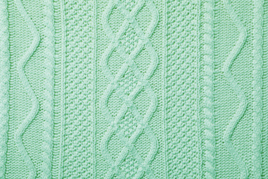 Surface of winter clothing as background. Image toned in mint color 