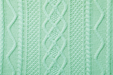 Image of Surface of winter clothing as background. Image toned in mint color 