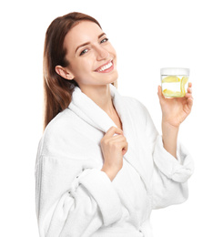 Young woman with glass of lemon water on white background