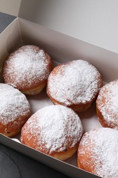 Photo of Delicious sweet buns in box on table, above view