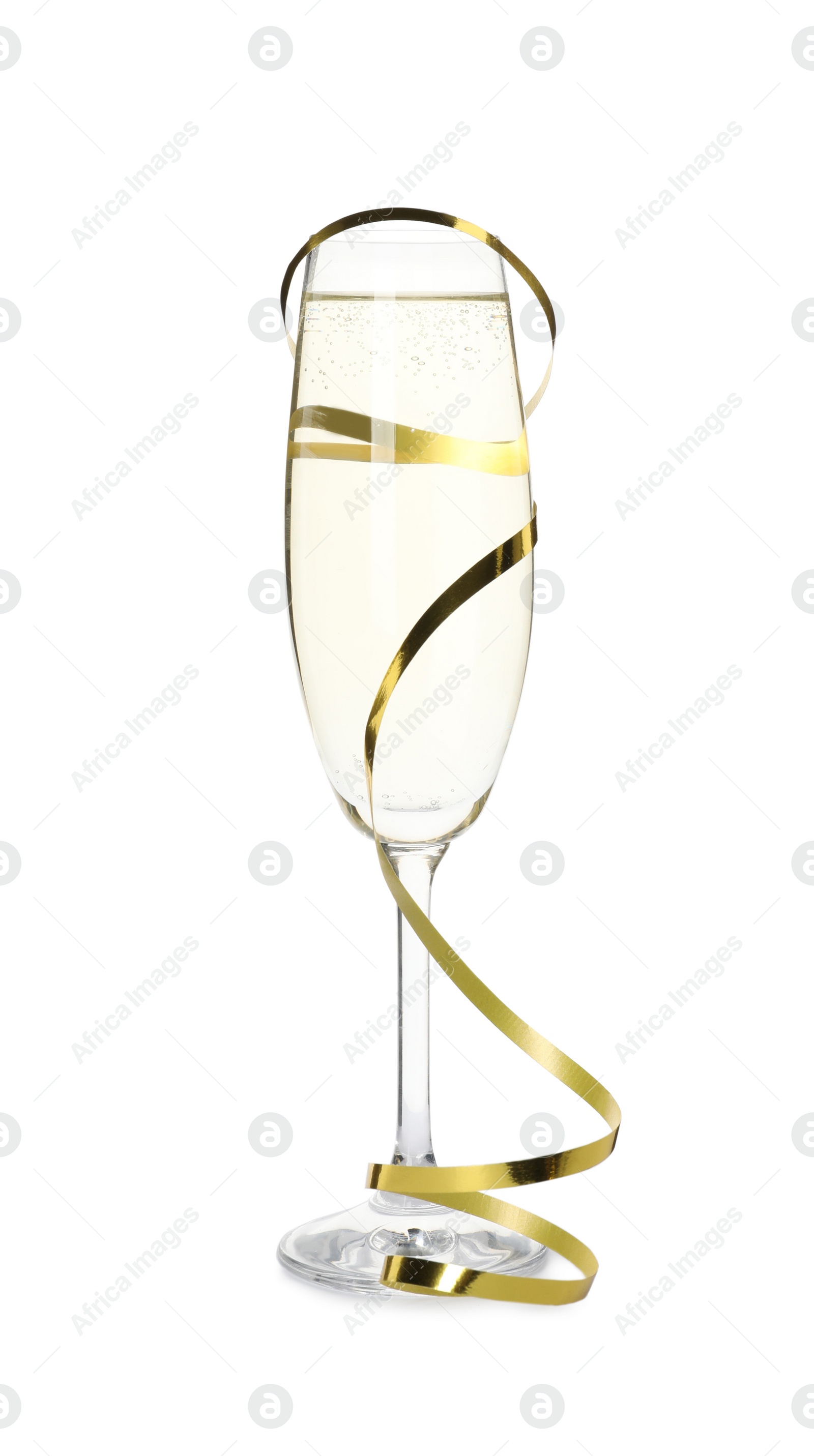 Photo of Glass of champagne and serpentine streamer on white background