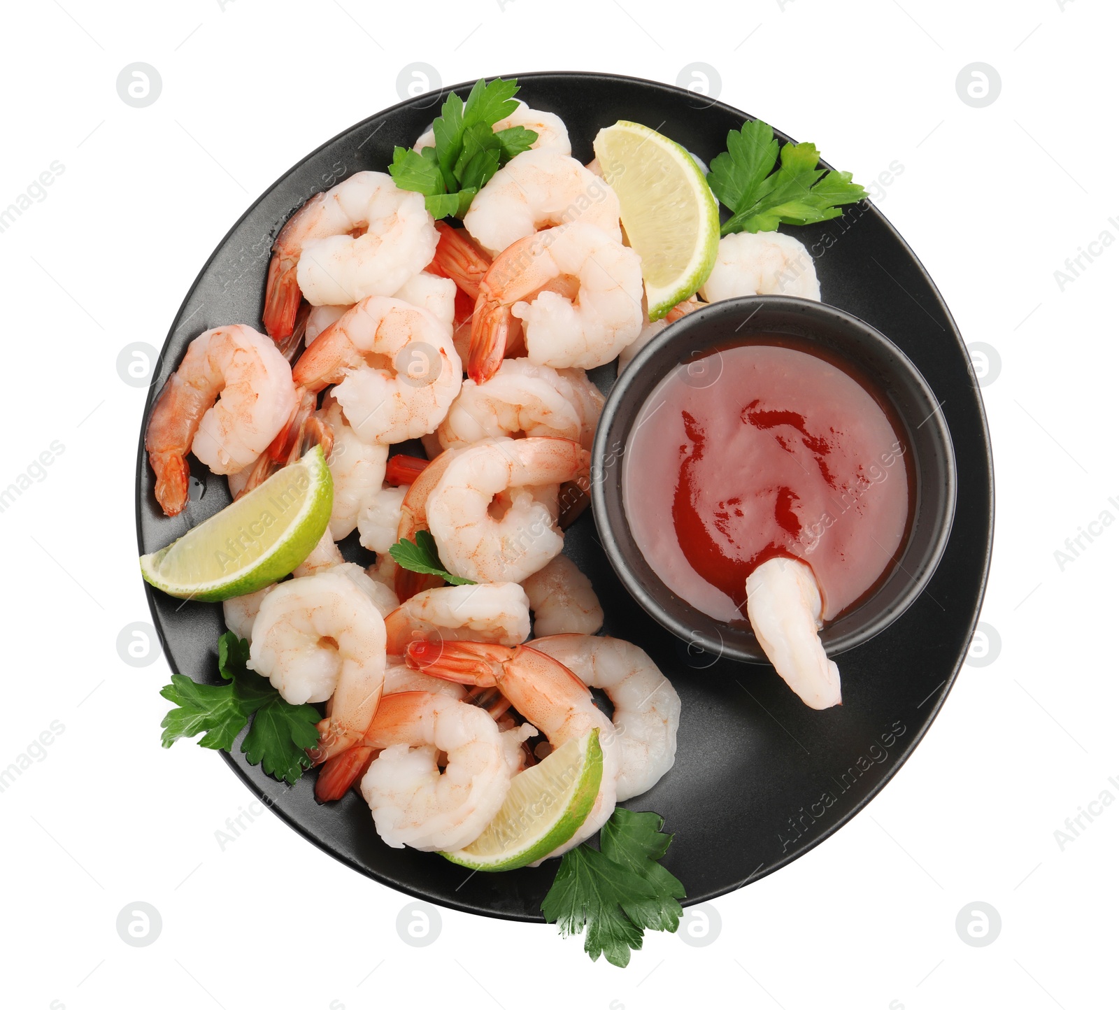 Photo of Tasty boiled shrimps with cocktail sauce, lime and parsley isolated on white, top view