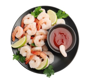 Tasty boiled shrimps with cocktail sauce, lime and parsley isolated on white, top view