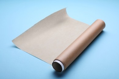 Roll of baking paper on light blue background