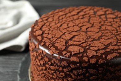 Photo of Delicious chocolate truffle cake on table, closeup