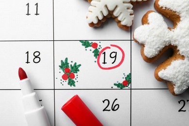 Photo of Saint Nicholas Day. Calendar with marked date December 19, marker and snowflake shape gingerbread cookies, top view