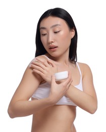 Photo of Beautiful young Asian woman applying body cream onto shoulder on white background