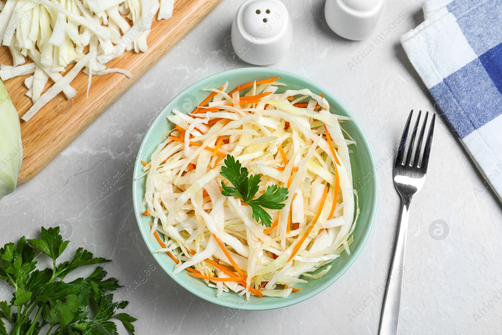 Photo of Flat lay composition with cabbage salad on light grey marble table