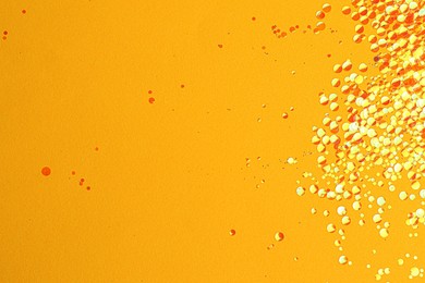 Shiny bright glitter on yellow background. Space for text