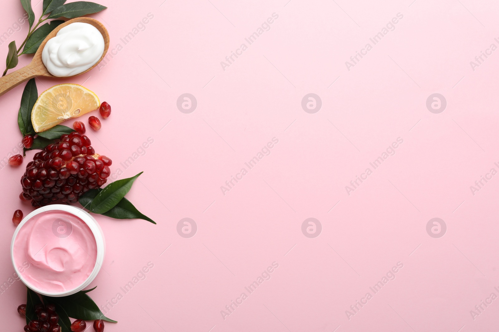 Photo of Flat lay composition with natural homemade mask, pomegranate and ingredients on pink background. Space for text