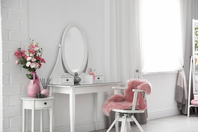 Stylish room interior with white dressing table