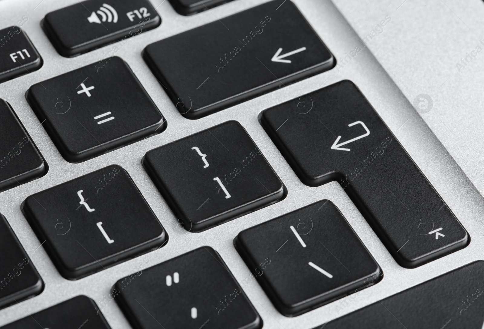 Photo of Modern laptop keyboard with black buttons, closeup view