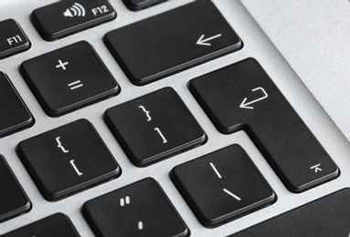 Photo of Modern laptop keyboard with black buttons, closeup view