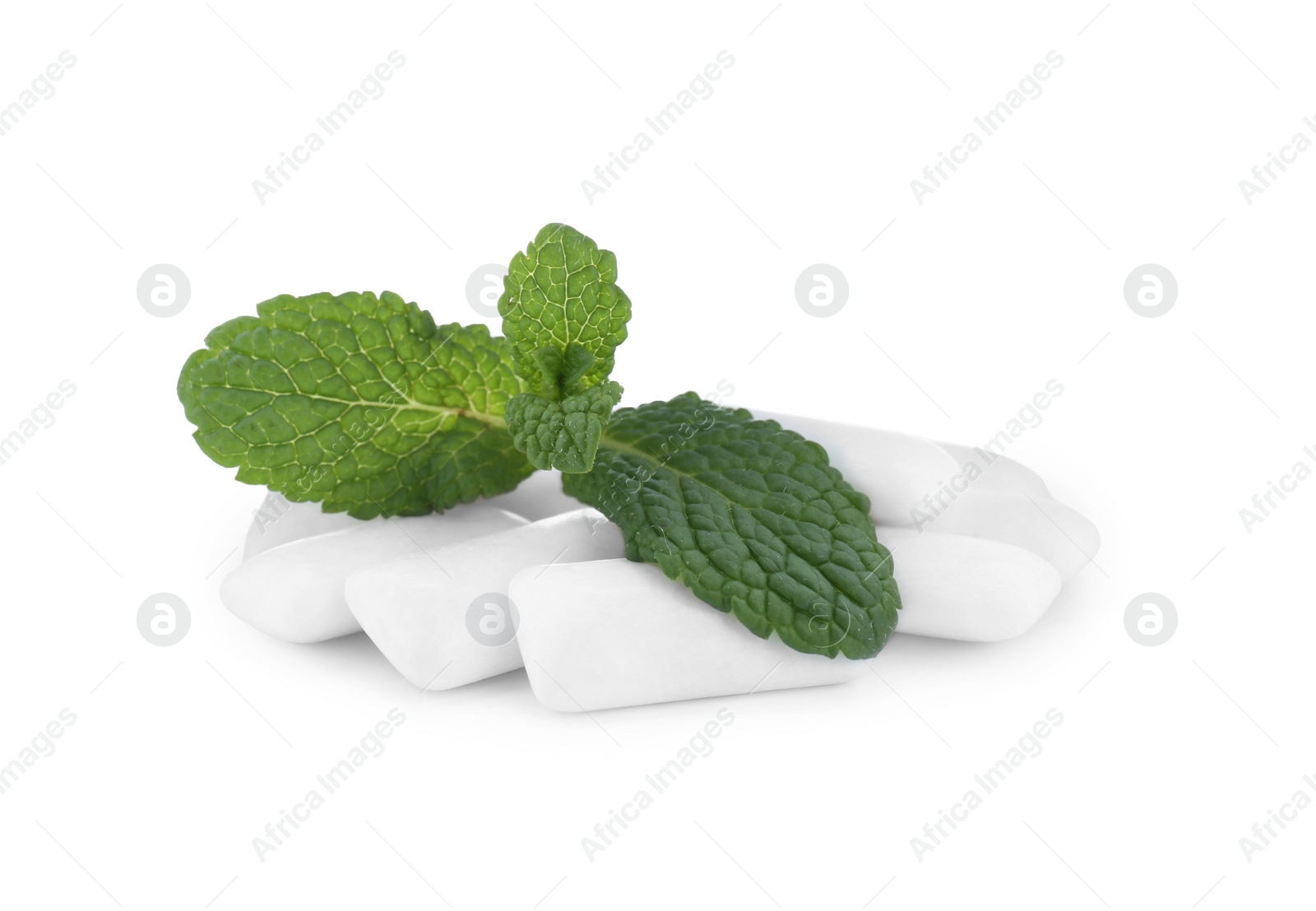 Photo of Heap of chewing gum pieces and mint on white background