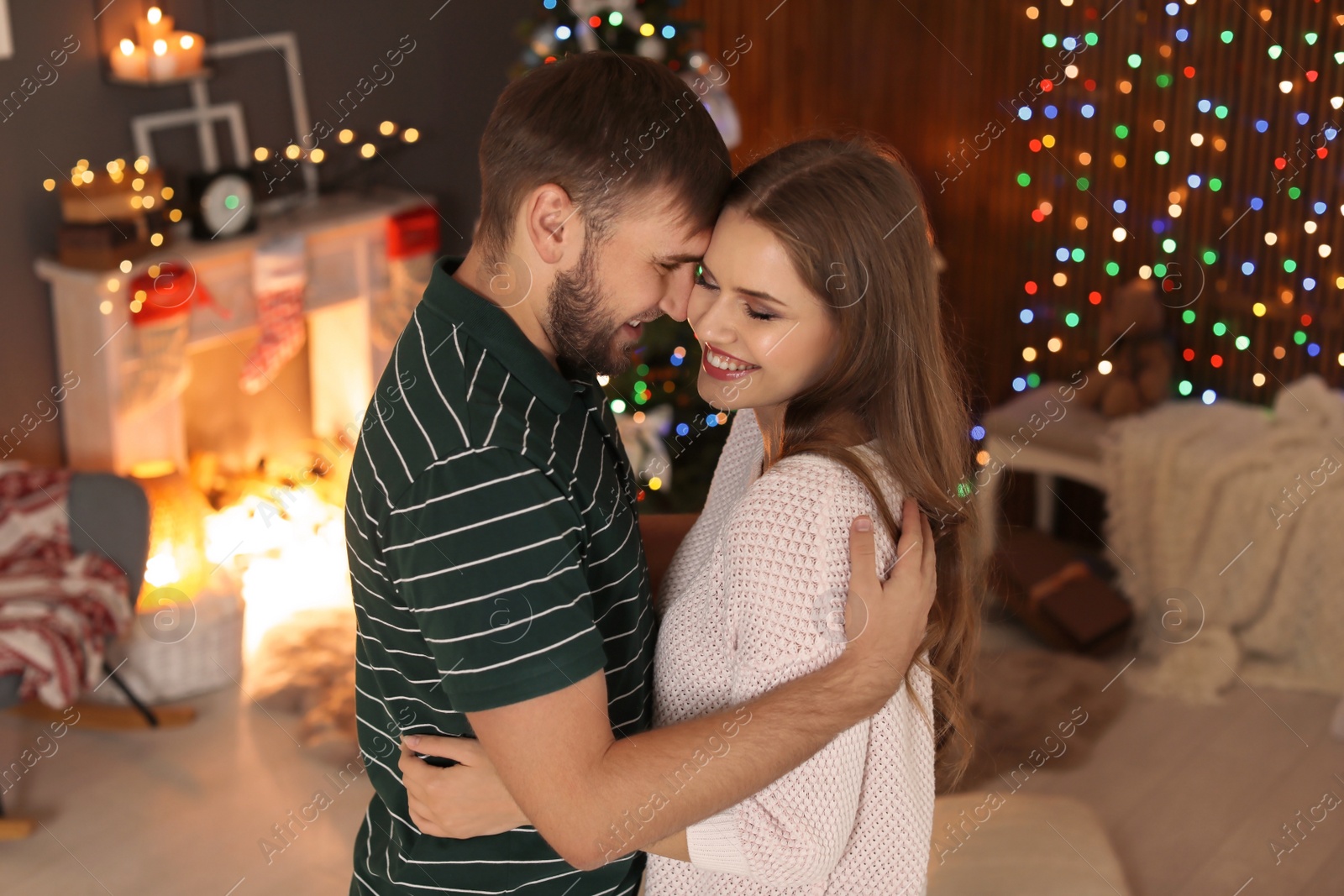 Photo of Happy young couple celebrating Christmas at home