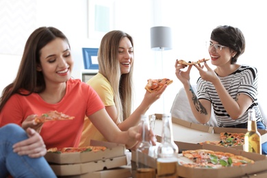 Photo of Young people having fun party with delicious pizza indoors
