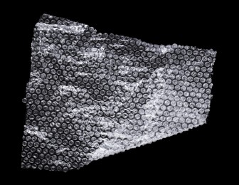 Photo of Transparent bubble wrap on black background, top view