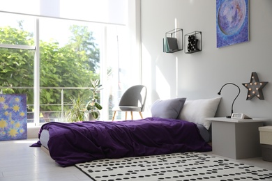 Modern teenager's room interior with comfortable bed and stylish design elements