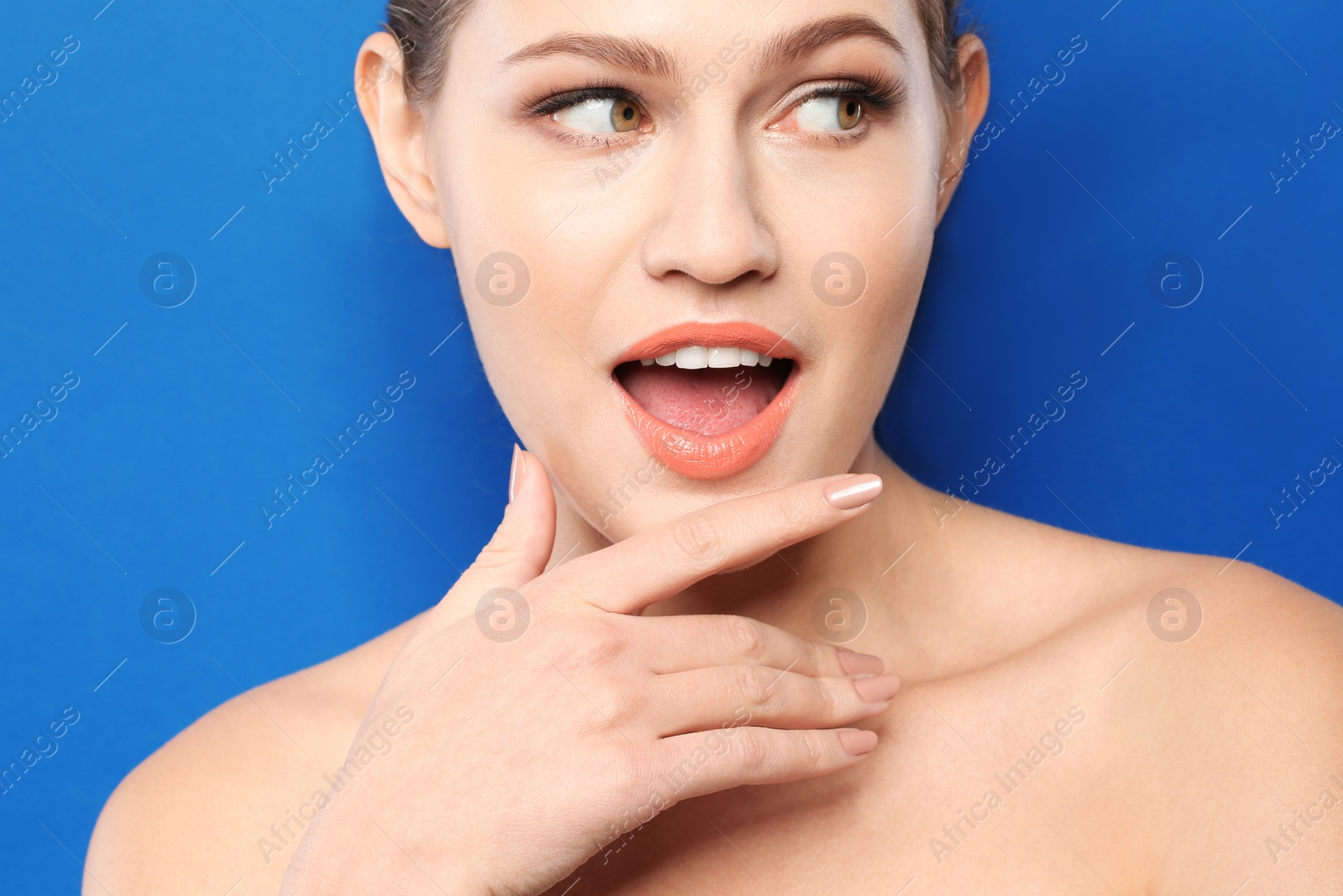 Photo of Young woman wearing beautiful lipstick on color background
