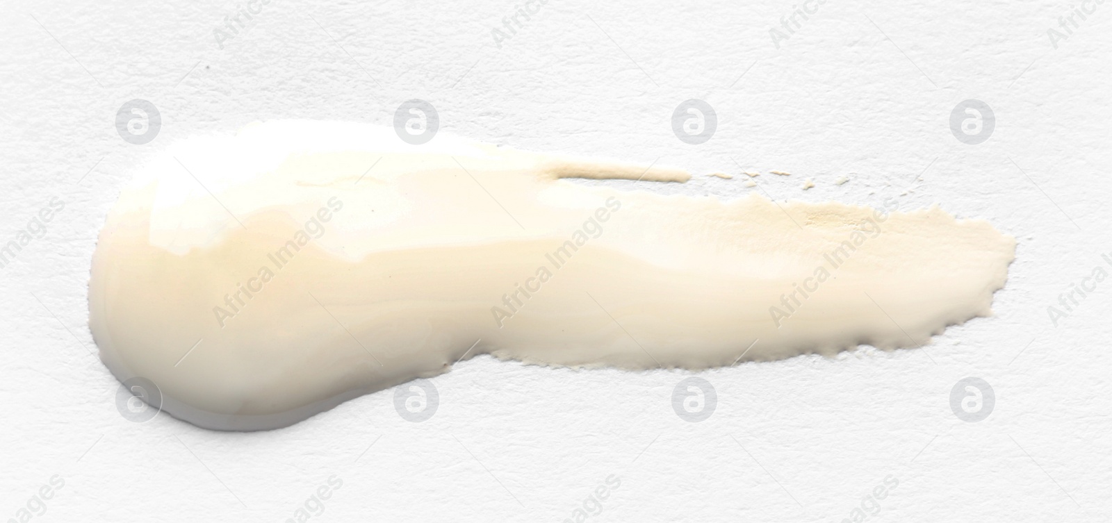 Photo of Abstract brushstroke of white paint isolated on white