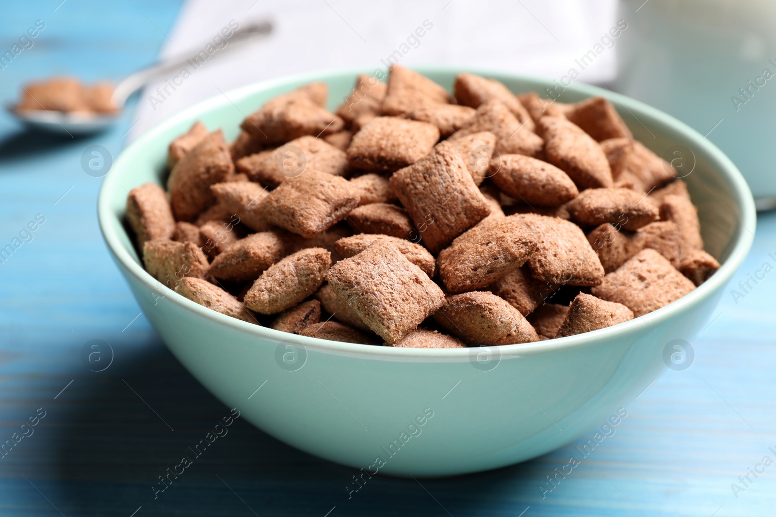 Photo of Delicious chocolate corn pads on light blue wooden table, closeup