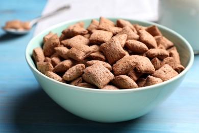 Delicious chocolate corn pads on light blue wooden table, closeup