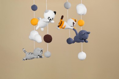 Photo of Cute baby crib mobile on beige background