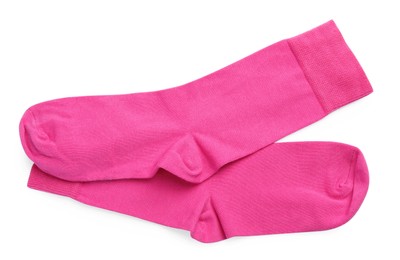 Pair of pink socks on white background, top view