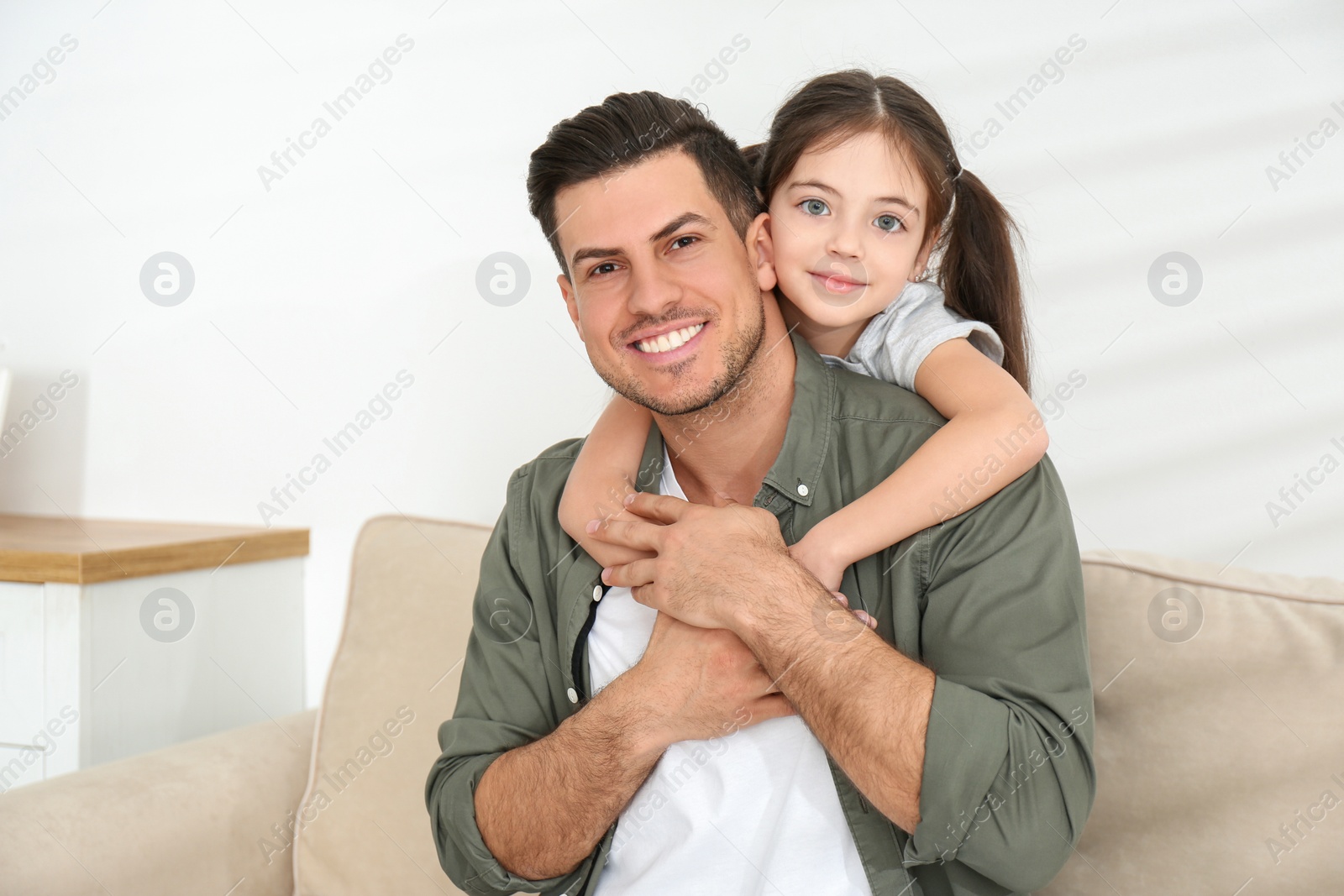 Photo of Dad and daughter spending time together at home. Happy Father's Day