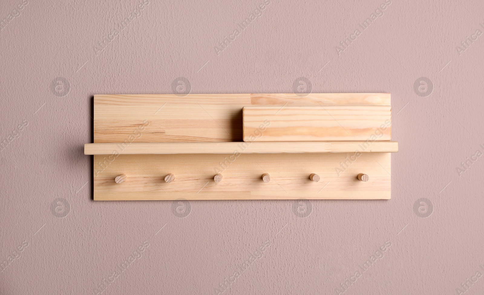 Photo of Wooden hanger for keys on color wall