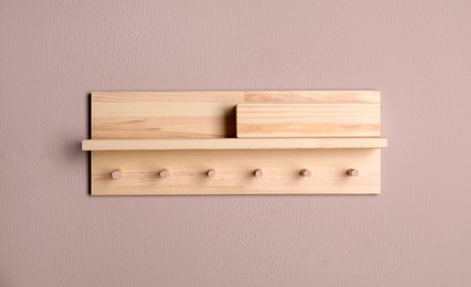 Wooden hanger for keys on color wall