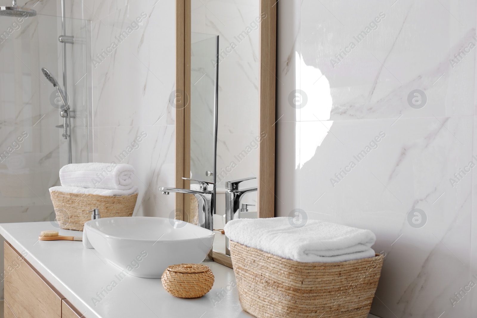 Photo of Large mirror and vessel sink in bathroom