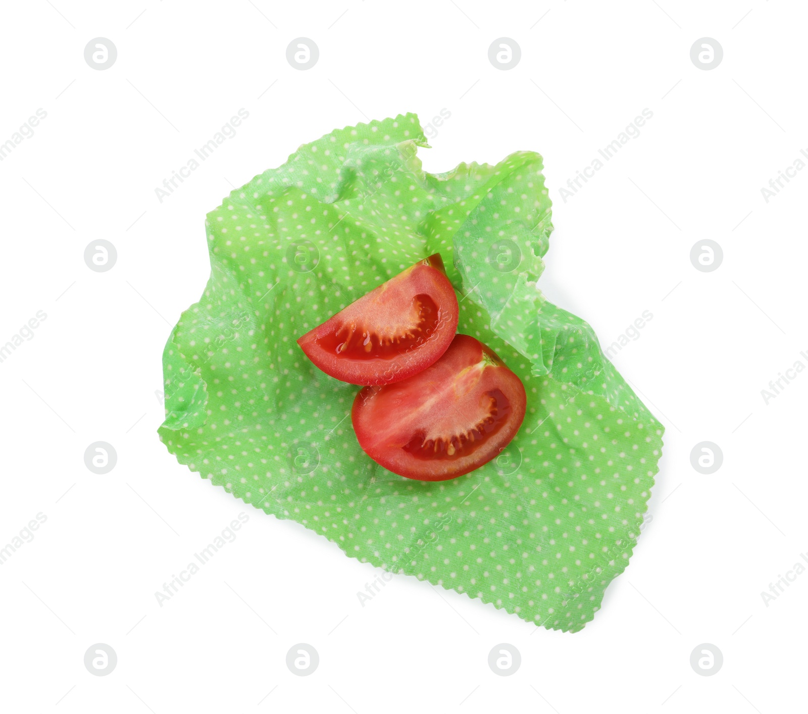 Photo of Slices of fresh tomato in beeswax food wrap isolated on white, top view