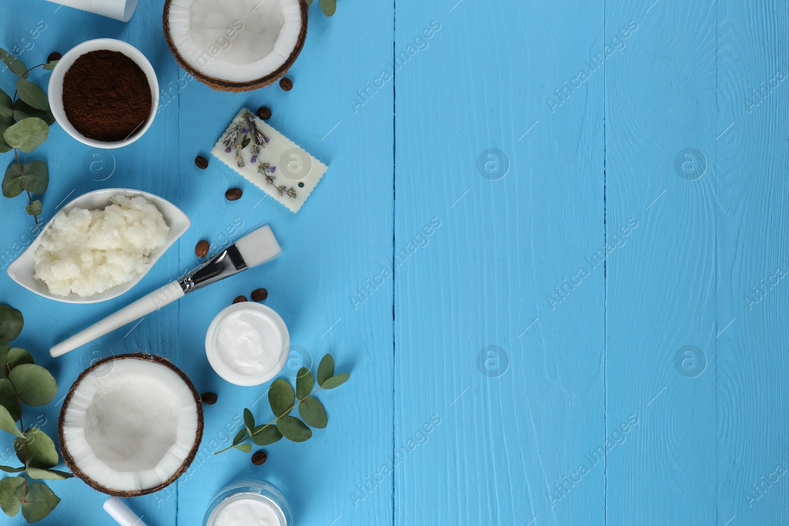 Photo of Flat lay composition with homemade cosmetic products and fresh ingredients on light blue wooden table. Space for text